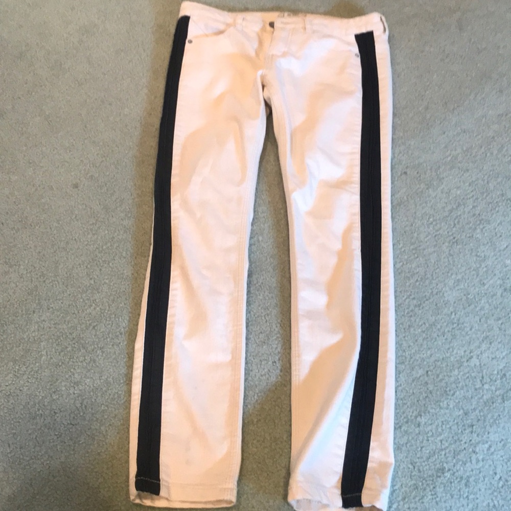 Whitish pants with black leather strip down side